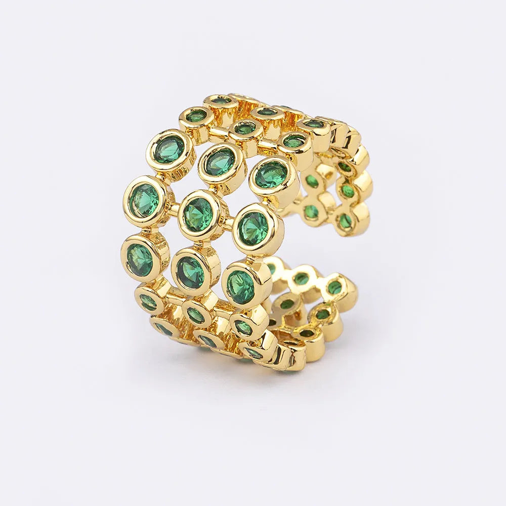 Copper ring with 18K gold plating showing three-layer exaggerated design and green zirconia stones