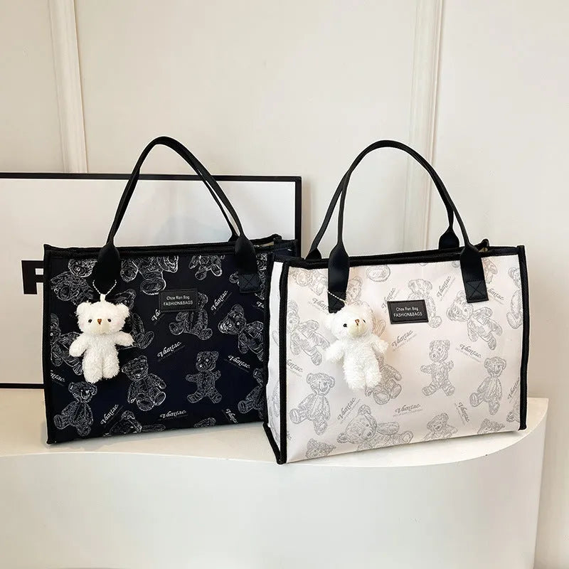 Women's black canvas tote bag with rhombus pattern print and shoulder strap