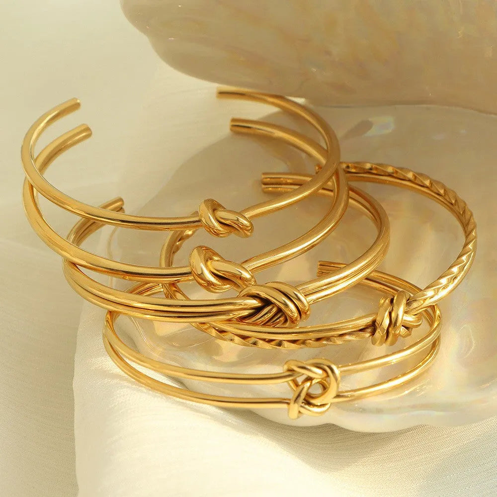 Adjustable C-shaped stainless steel bracelet with knotted double-layer design in gold or silver finish