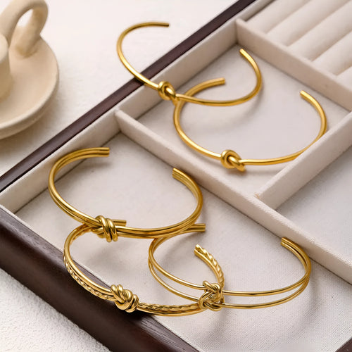 Adjustable C-shaped stainless steel bracelet with knotted double-layer design in gold or silver finish