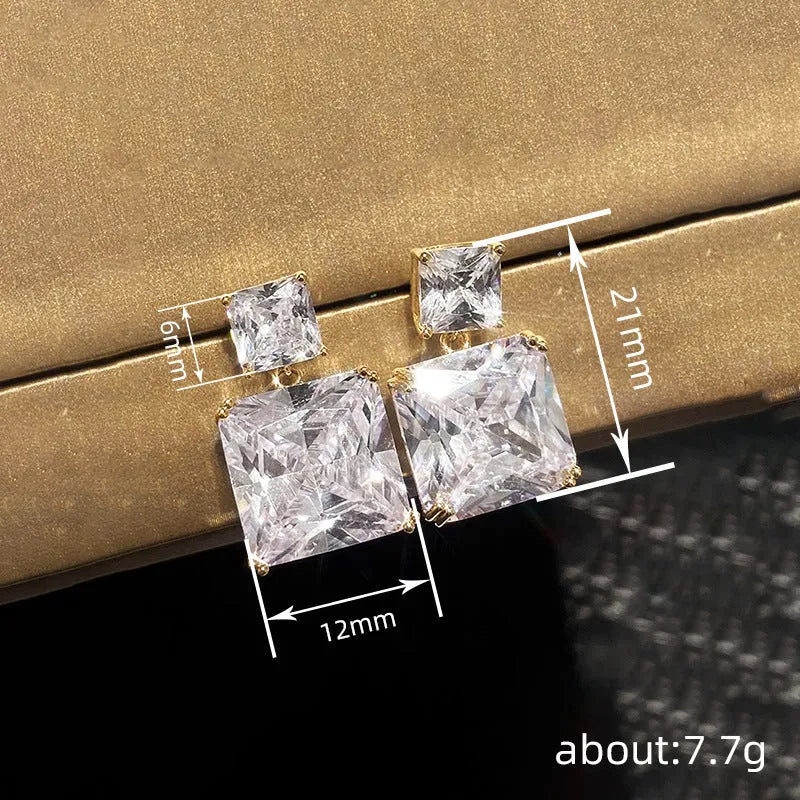A pair of geometric square copper earrings with a quadrilateral design, shown in white gold and gold colour options.
