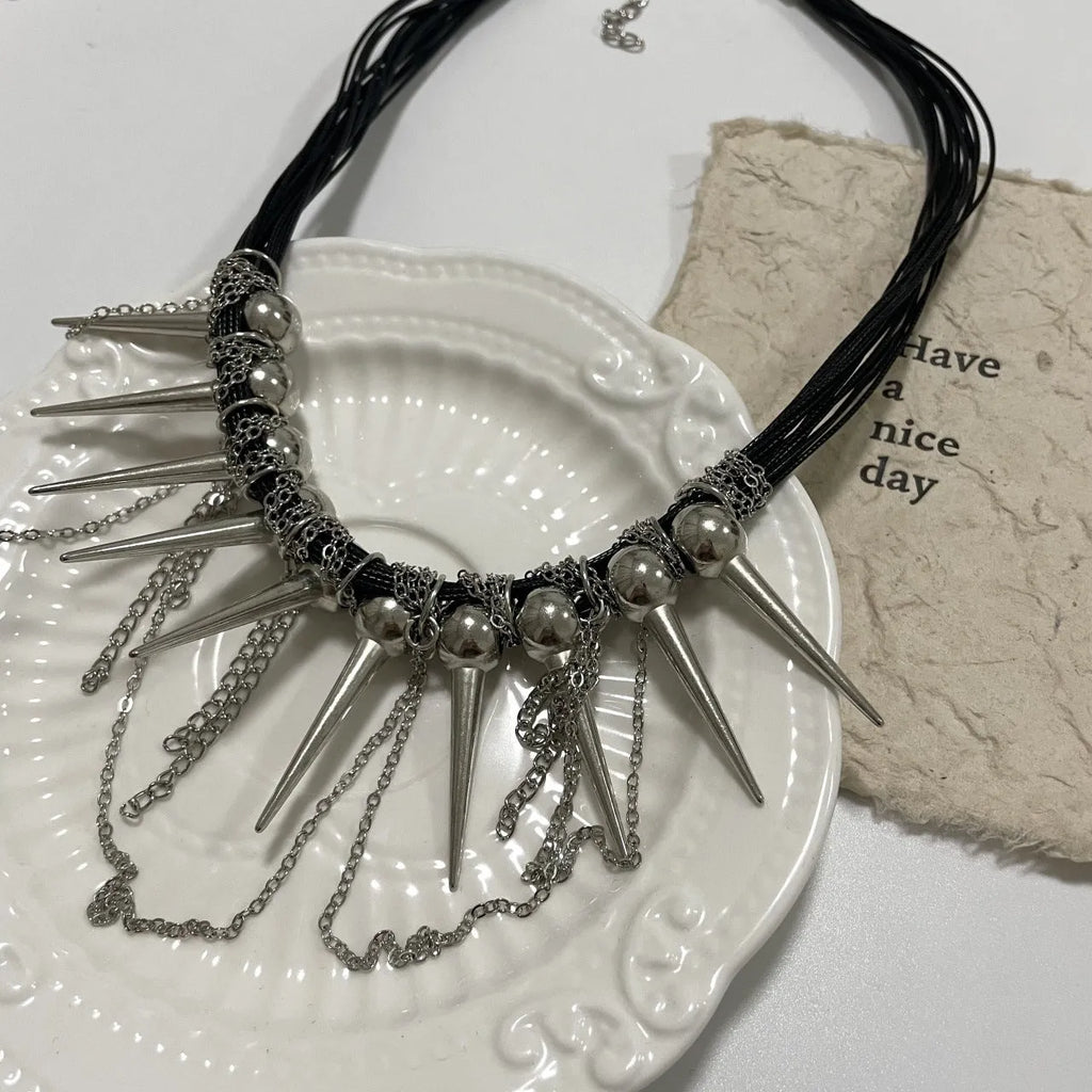 Women's leather necklace with winding rivet beads and a tassel in casual style.