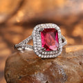 Women's square ring with copper band and red rhinestones on a geometric face.