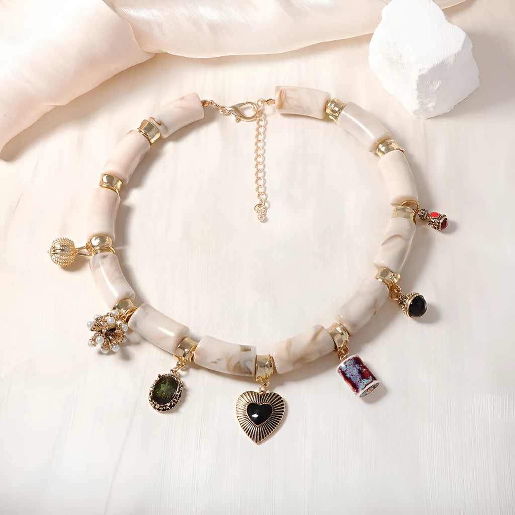 Close-up of a heart-shaped bamboo motif pendant necklace for women on an electroplated chain.