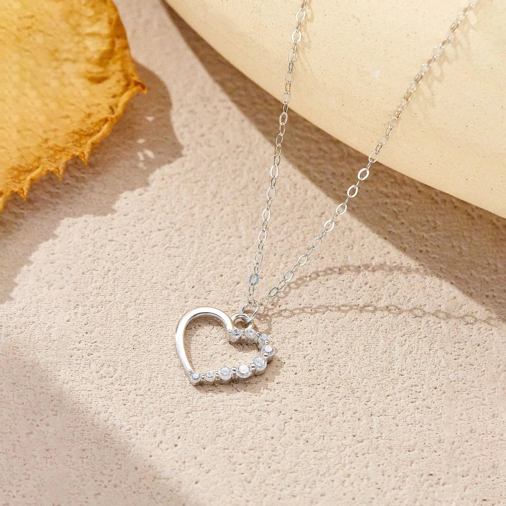 Sterling silver hollow heart necklace with circular details on a regular chain