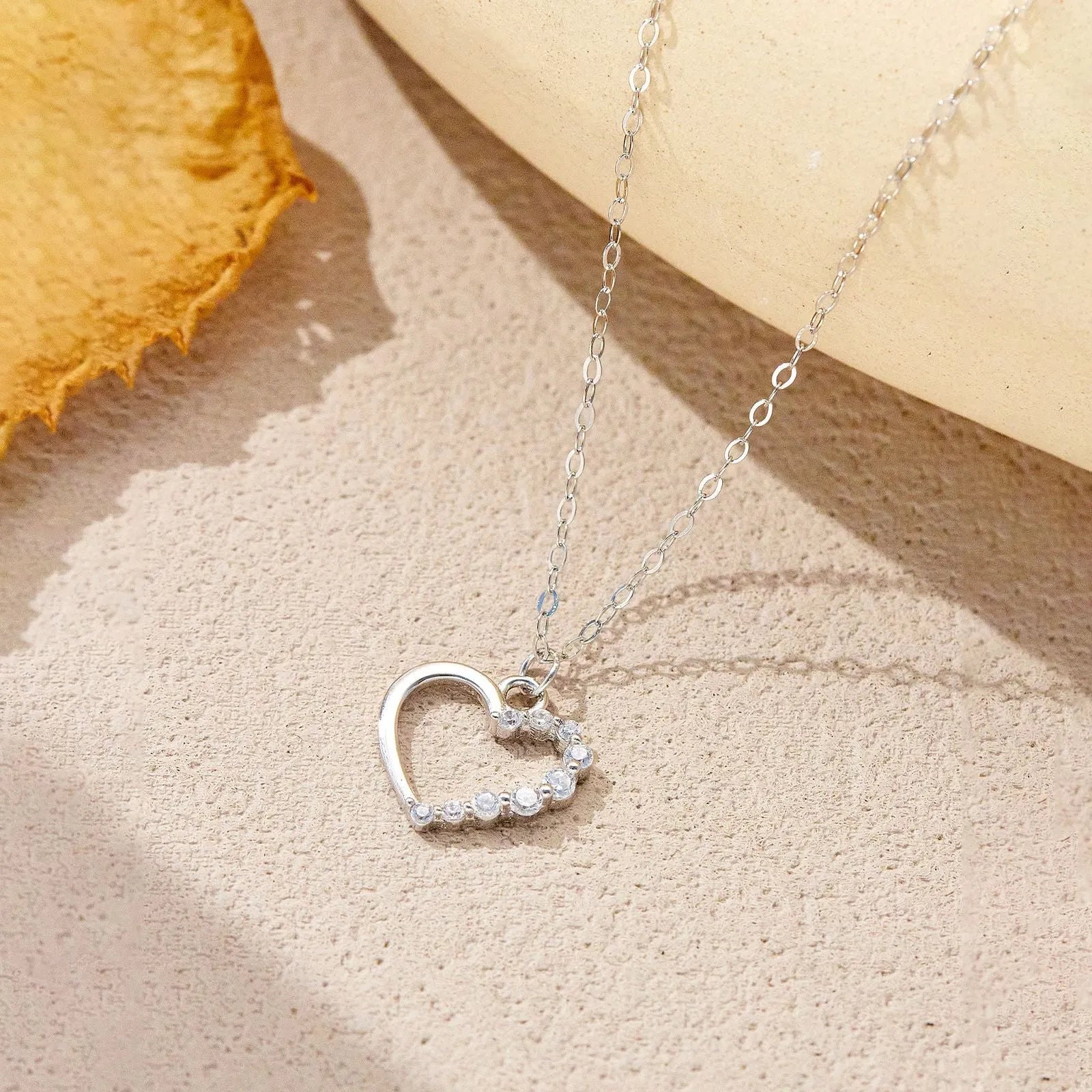 Sterling silver hollow heart necklace with circular details on a regular chain