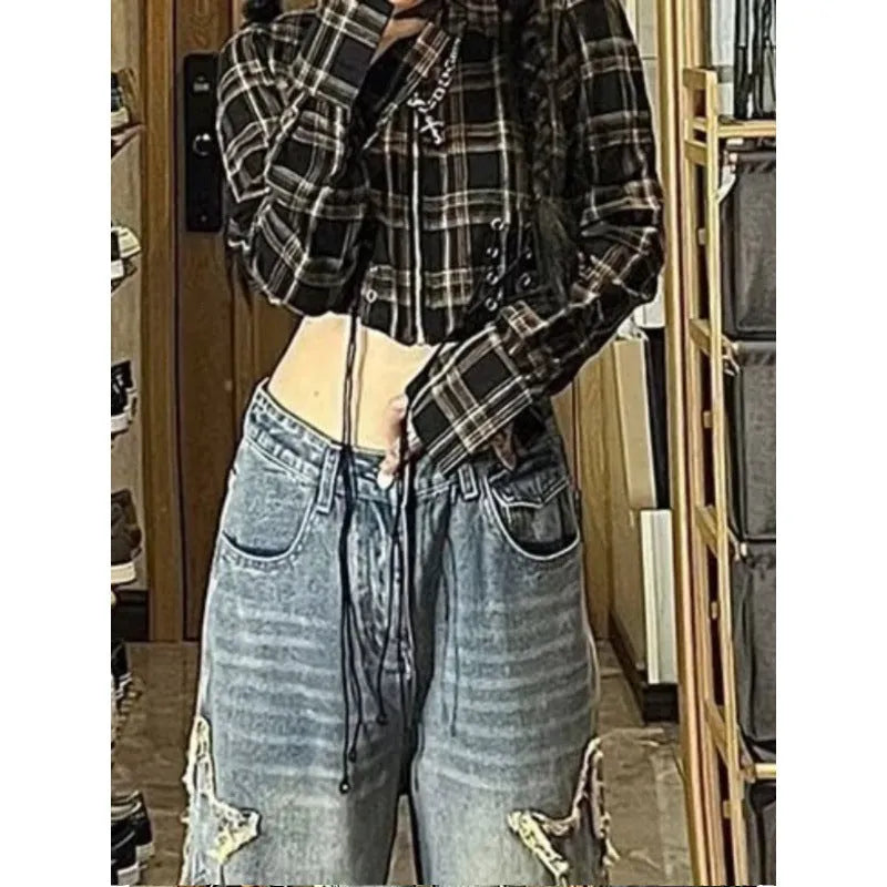 Blue women's straight-leg jeans with a high waist on a hanger, showing the denim texture and cut.
