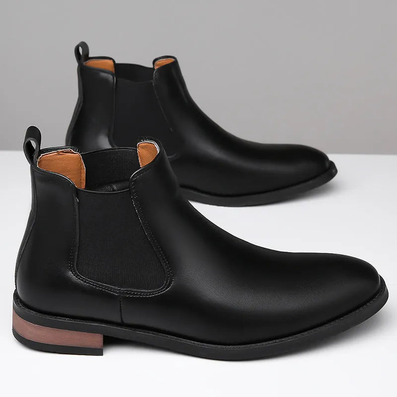 Men's black pointed toe Chelsea boots with a round toe shape and rubber sole.