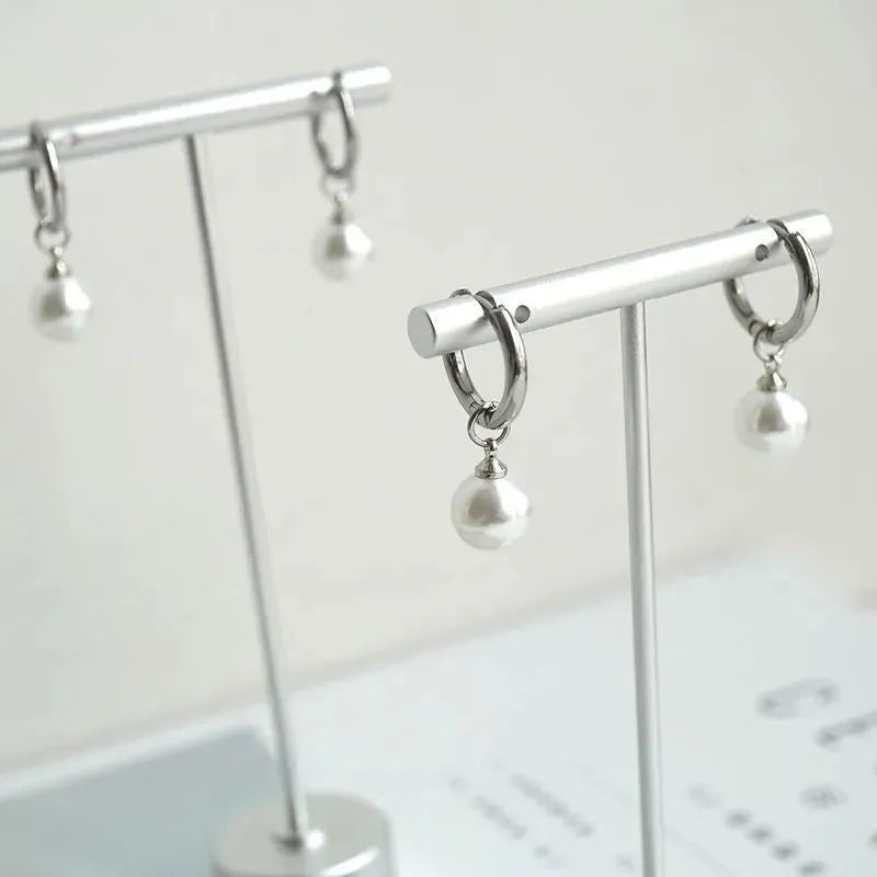 Pair of pearl-coloured geometric round drop earrings made from titanium steel alloy