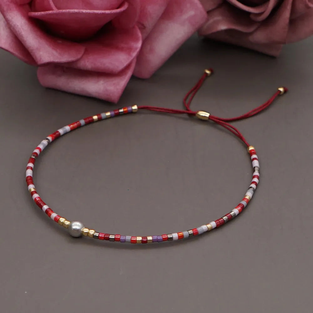 A colourful Bohemian style beaded bracelet with semi-precious stone and glass beads on an adjustable strap.