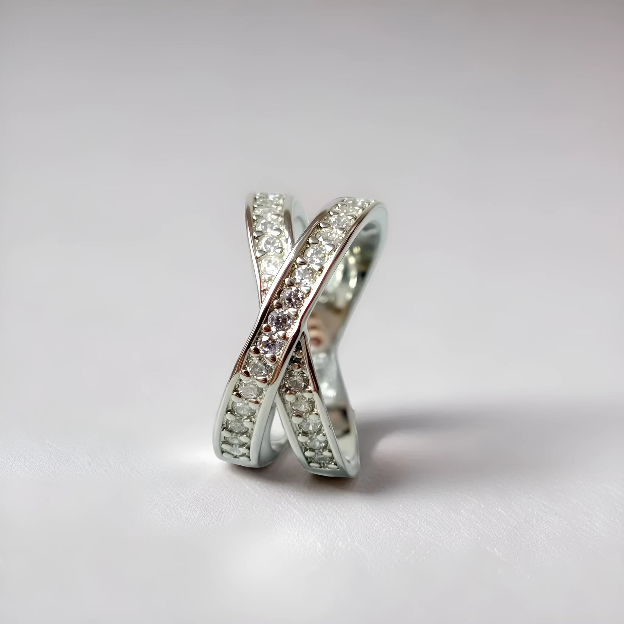 Geometric metal cross ring with micro-inlaid zircon stones in silver or rose gold finish