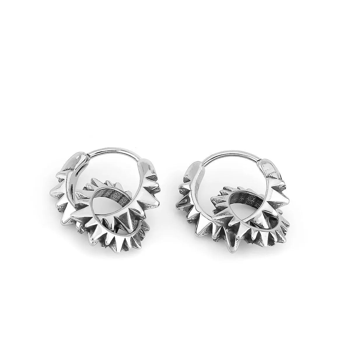 A pair of simple, polished stainless steel round ring earrings in a steel colour on a white background.