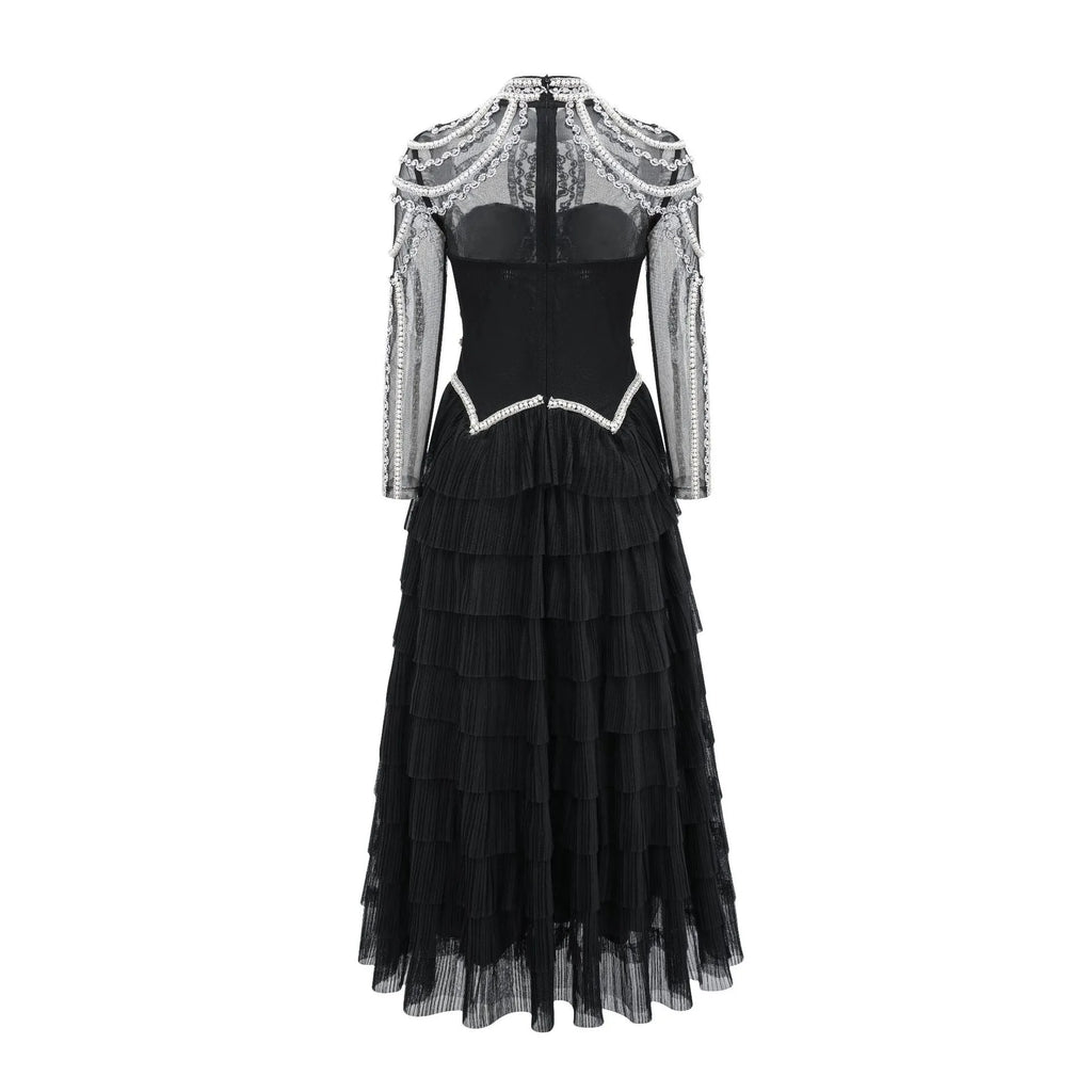 Black women's long sleeve formal dress with detailed beaded craftwork on the front.