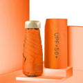 Closed five-fold mini pocket sun umbrella with alloy frame and rubber handle, shown in a selection of available colours.