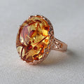 Close-up of a genuine beeswax amber ring in New Amber Type A colour on an alloy band.