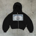 Unisex black zip-up hoodie jacket with white letter pattern and zippered side pockets on a model.
