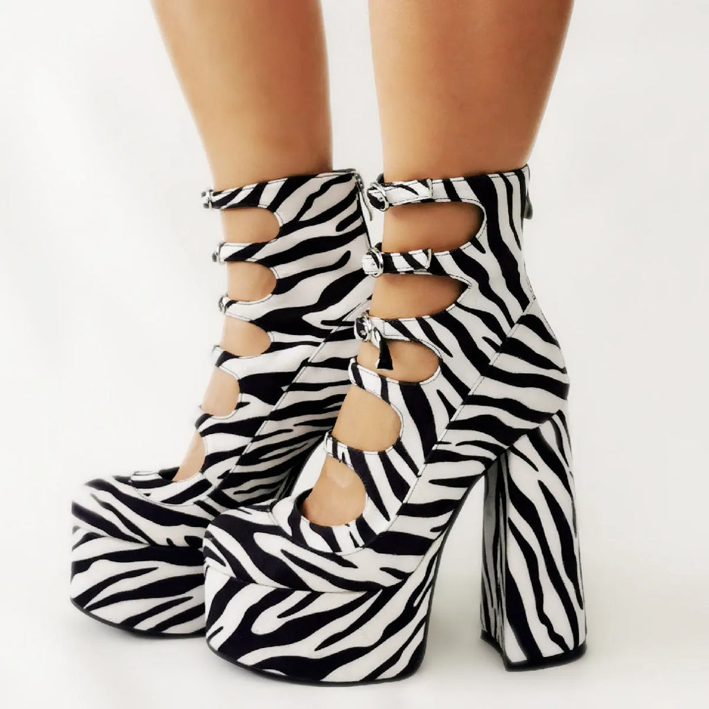 Black patent leather women's platform high heel boots with a thick heel and serpentine ankle buckle