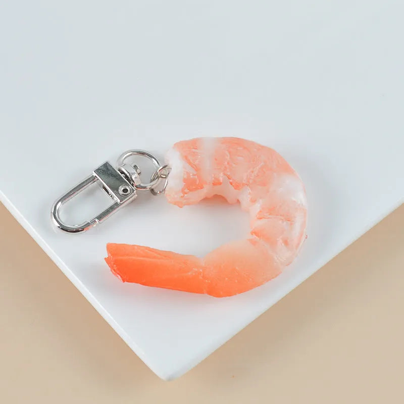 Realistic PVC shrimp-shaped keychain with door buckle attachment, shown against a white background.