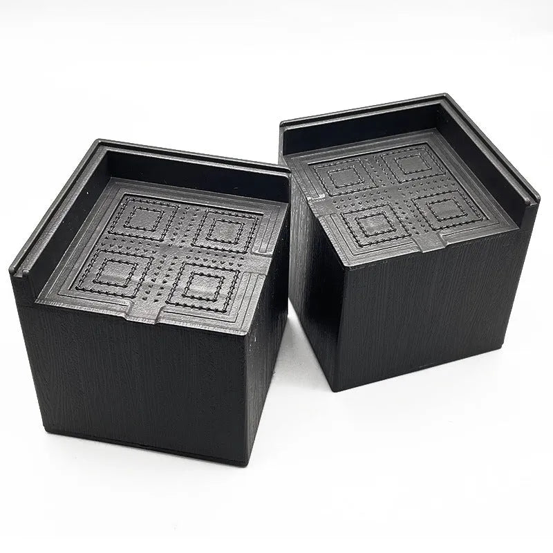 Four black thickened plastic furniture feet mats for height adjustment