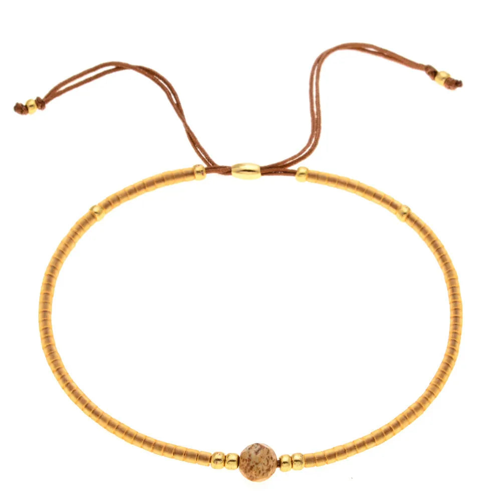 A colourful Bohemian style beaded bracelet with semi-precious stone and glass beads on an adjustable strap.