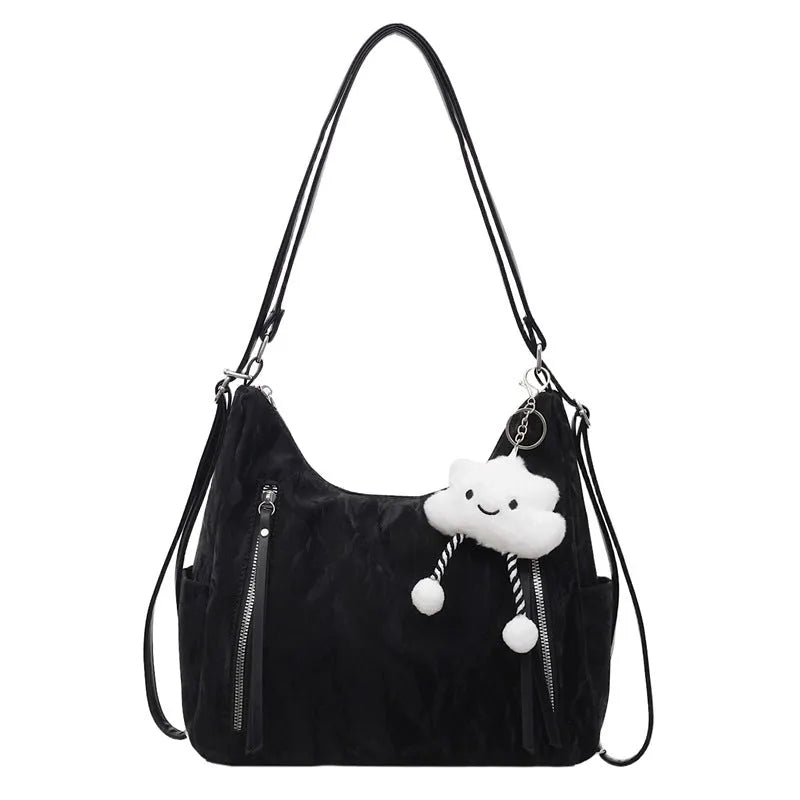 Soft black women's fashion backpack made from wear-resistant PU material, shown with a matching pendant.