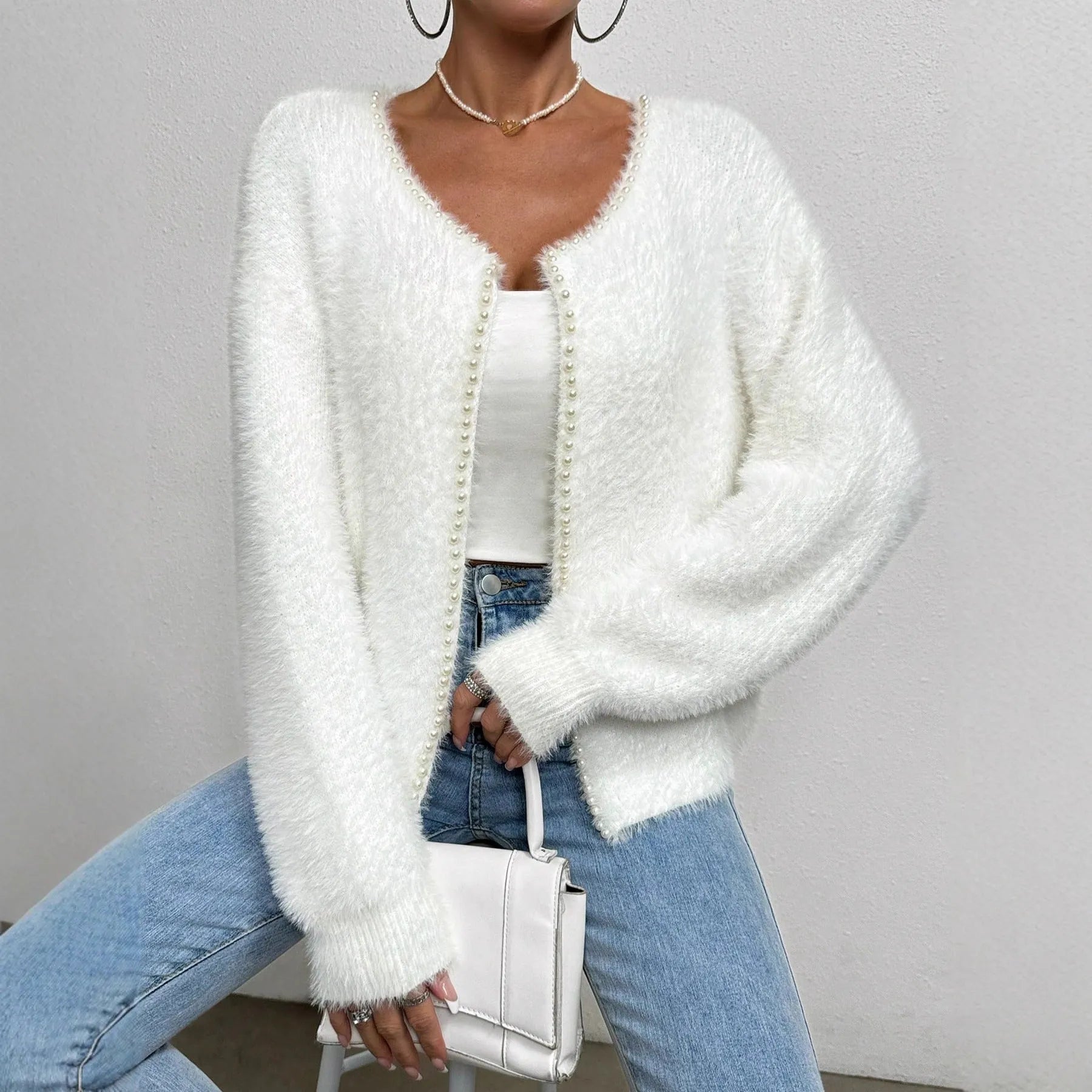 White women's cardigan sweater with V-neck design and beaded knitwork detailing