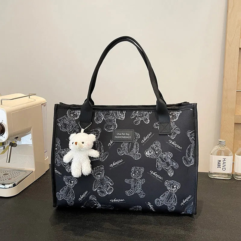 Women's black canvas tote bag with rhombus pattern print and shoulder strap