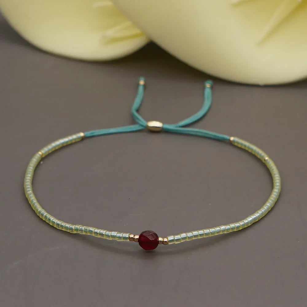 A colourful Bohemian style beaded bracelet with semi-precious stone and glass beads on an adjustable strap.