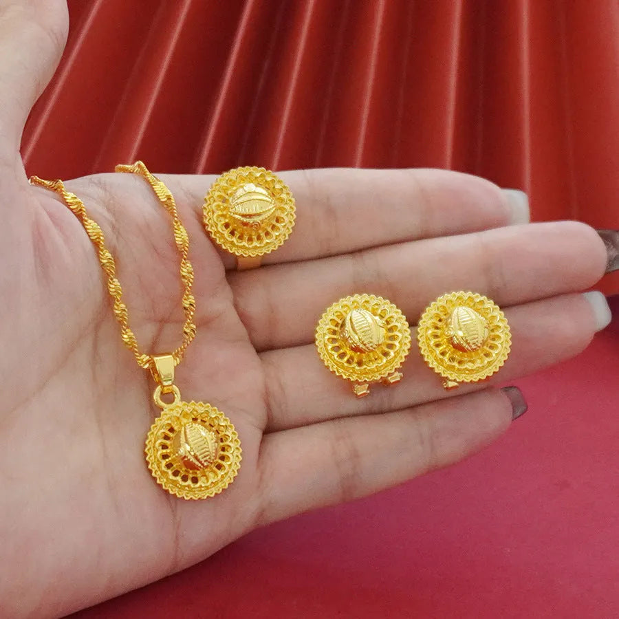 Gold-plated three-piece jewellery set with necklace, earrings, and ring in a floral design.