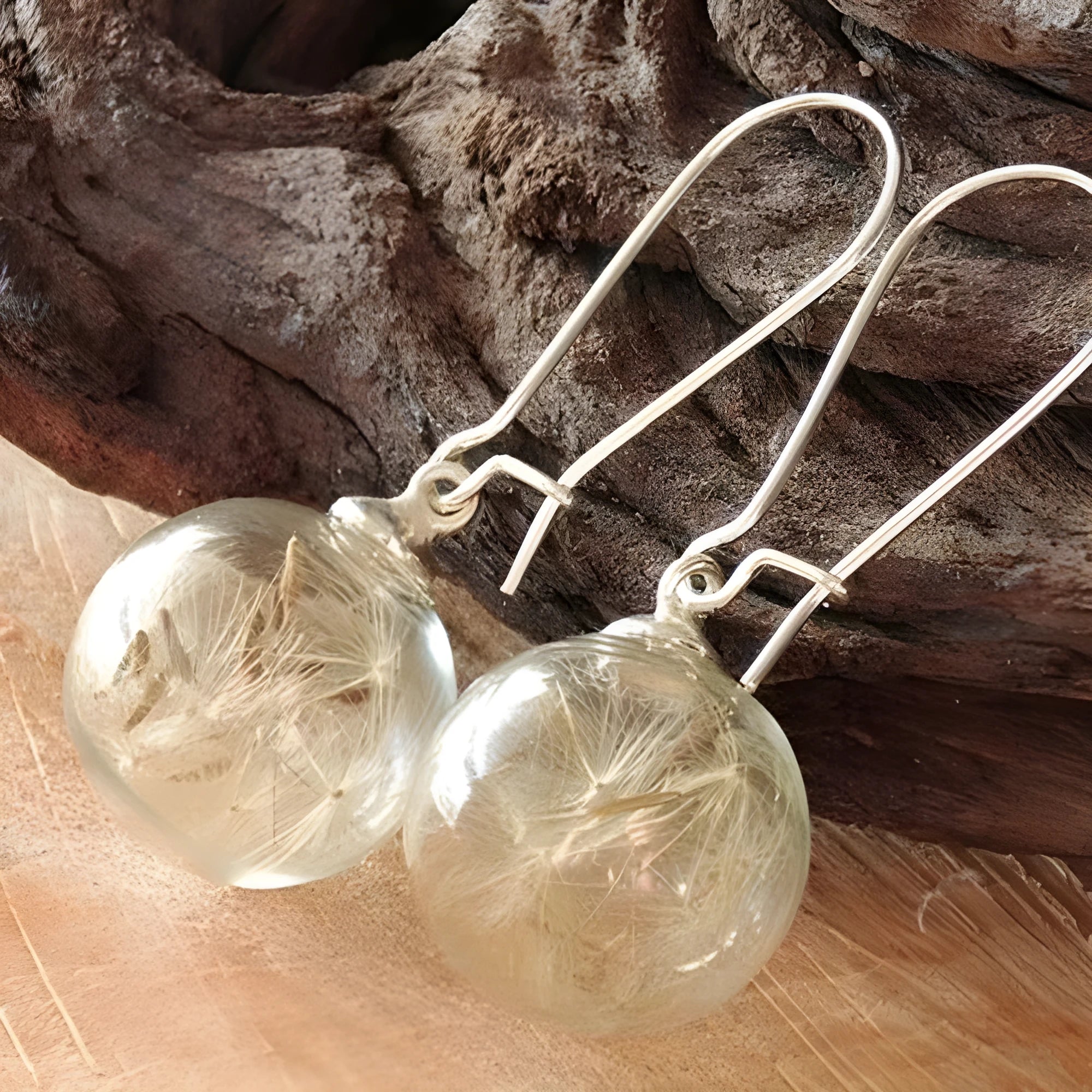 Transparent glass ball earrings with dandelion seed crystal design in silver and bronze finishes
