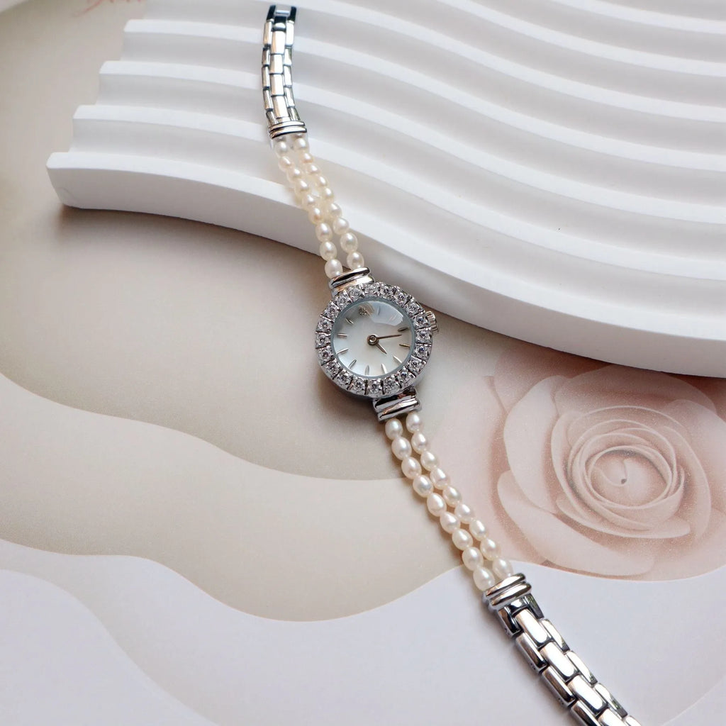Women's light gold bracelet watch with freshwater pearls, round mineral glass dial, and stainless steel folding buckle