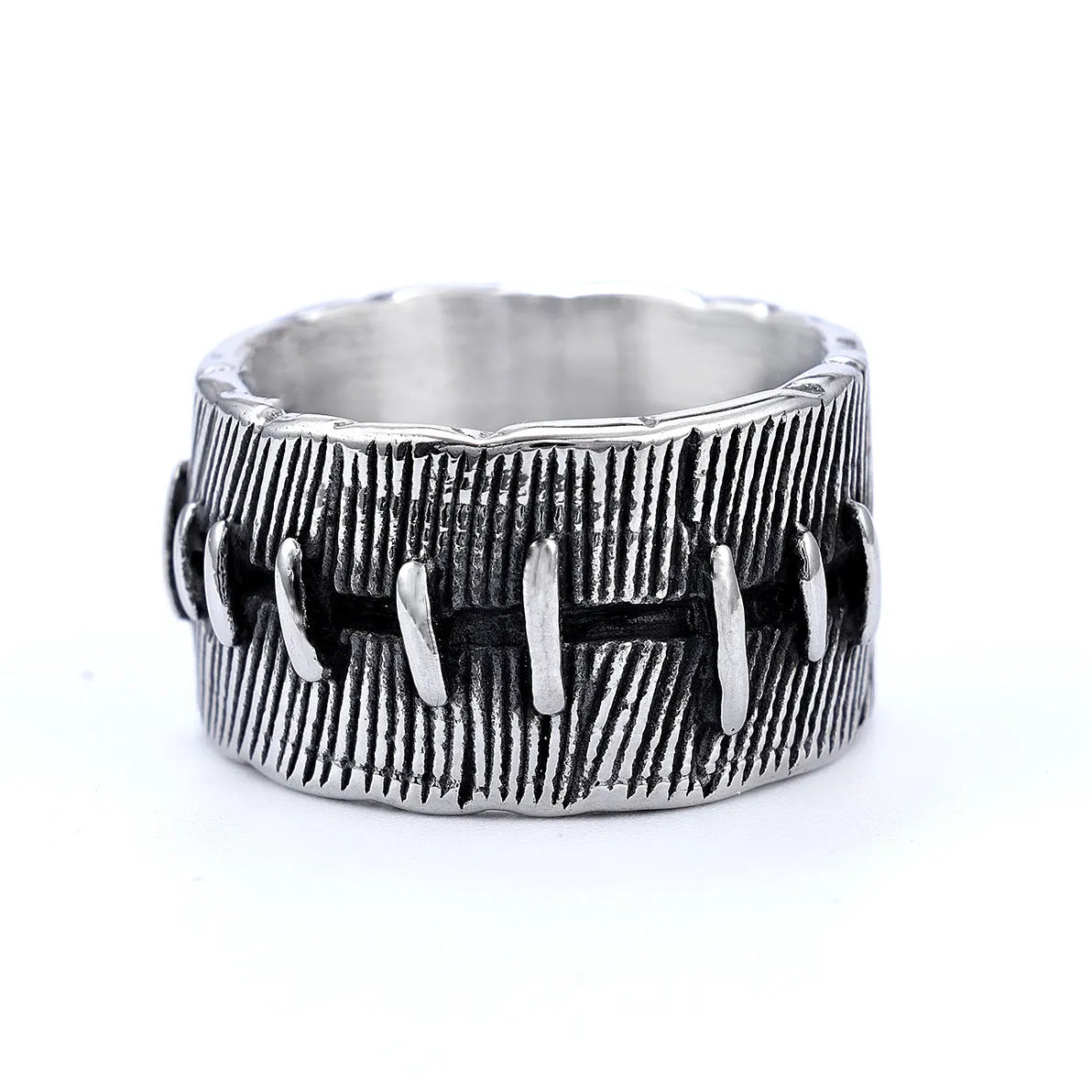Geometric dark punk titanium steel double ring in retro colour, showing stitched design on a hand.