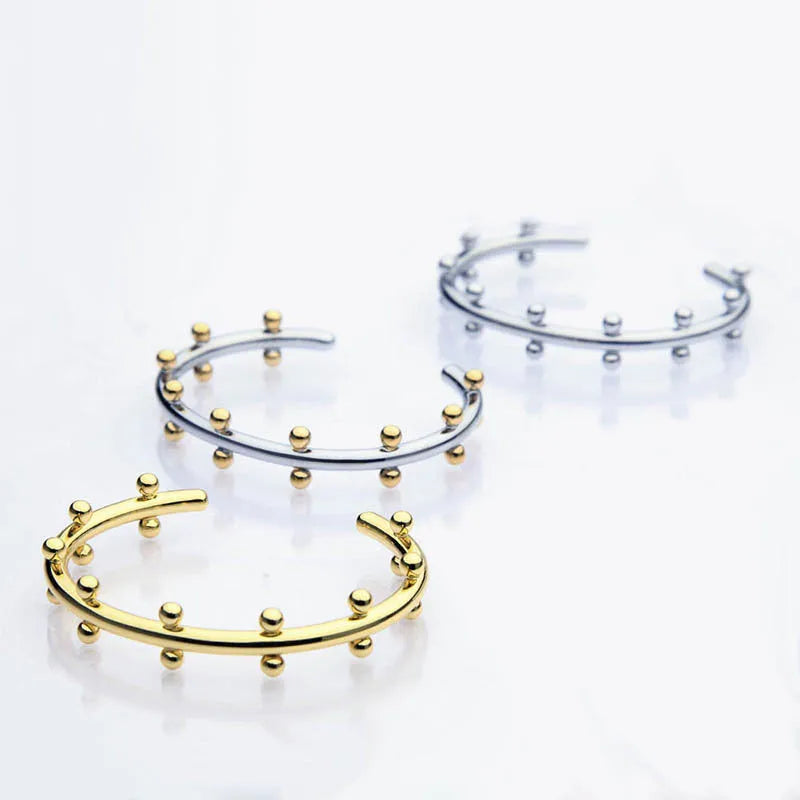 Stainless steel C-shaped rivet bean bead bracelet with alloy chain fastening in gold or steel colour