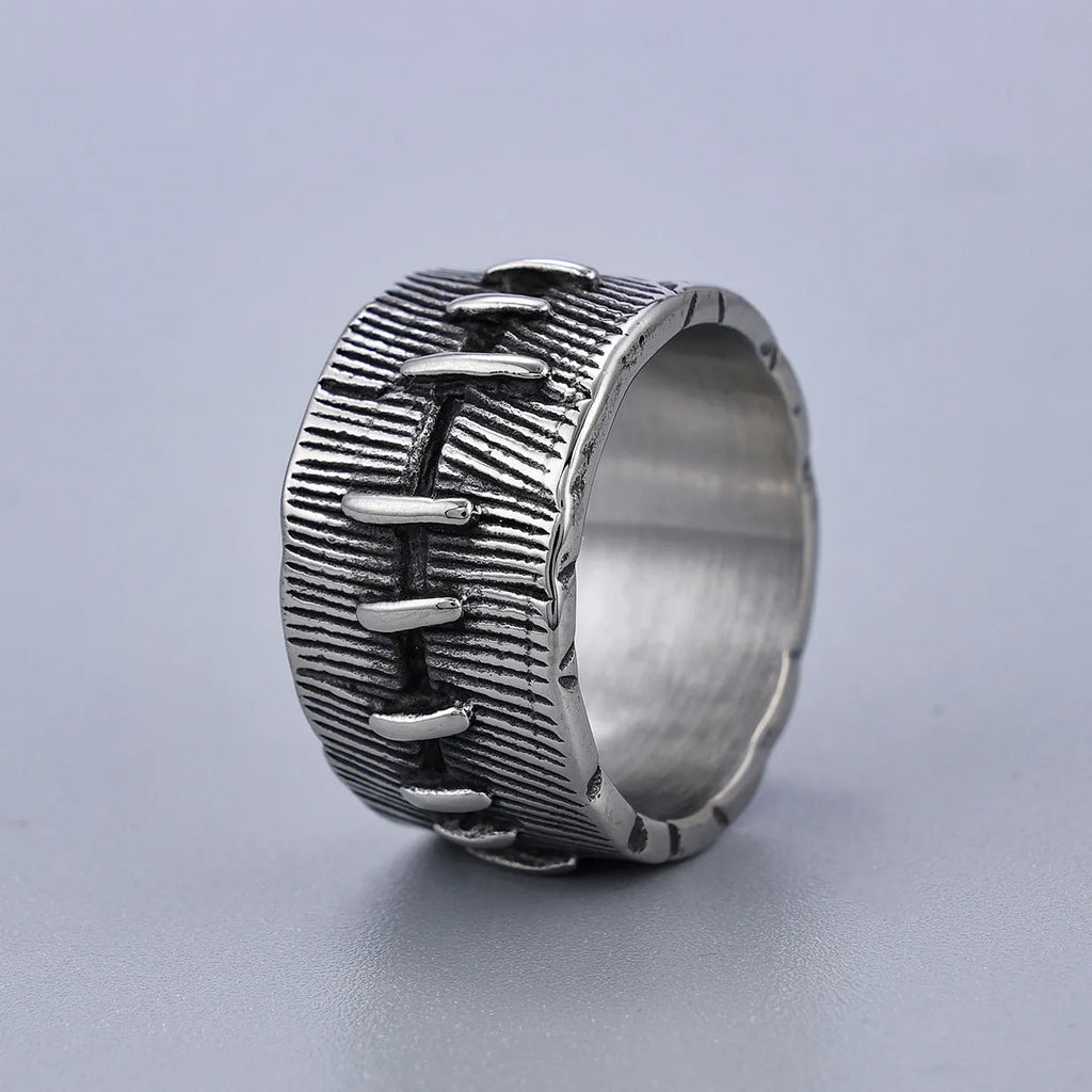 Geometric dark punk titanium steel double ring in retro colour, showing stitched design on a hand.