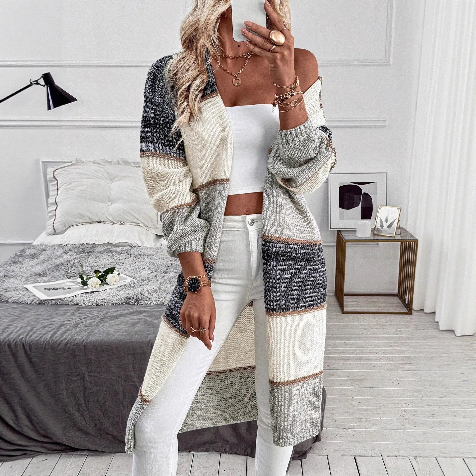 Grey stripes and plaid pattern on a women's loose fit knitted long cardigan with long sleeves.
