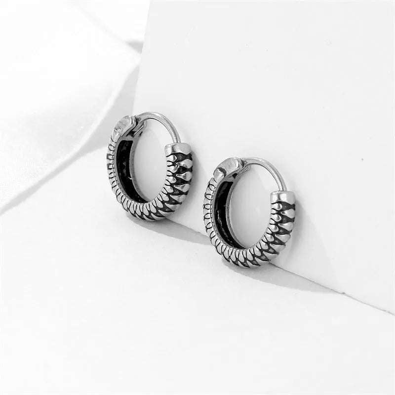 Silver geometric retro twist earrings with stripes made from titanium steel on a white background.