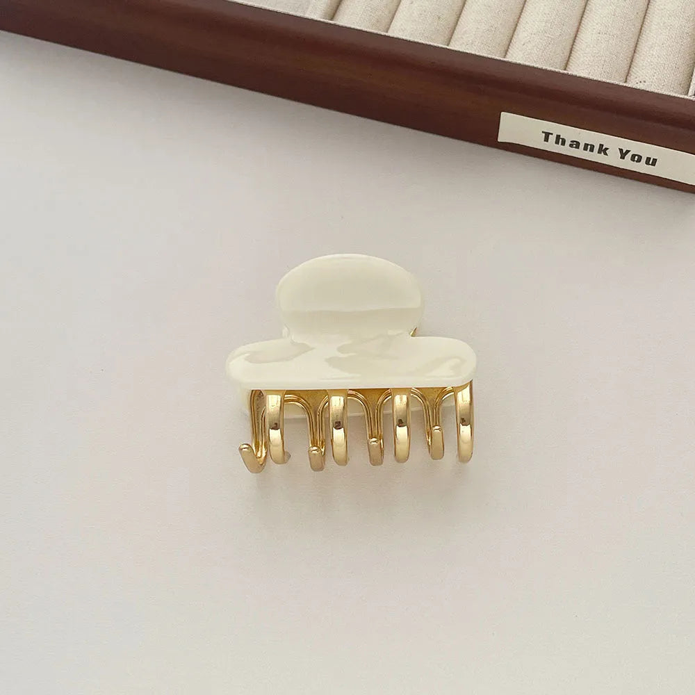 A medium-size retro-style hair barrette with a metal grip, in an alloy acrylic construction.