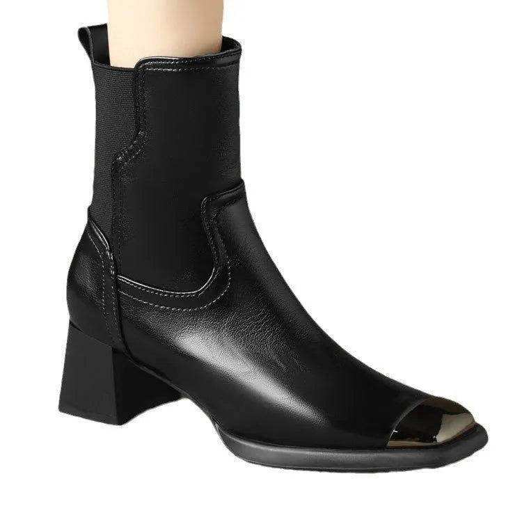Brown cowhide leather Martin boots with side zip and high heel on wooden floor