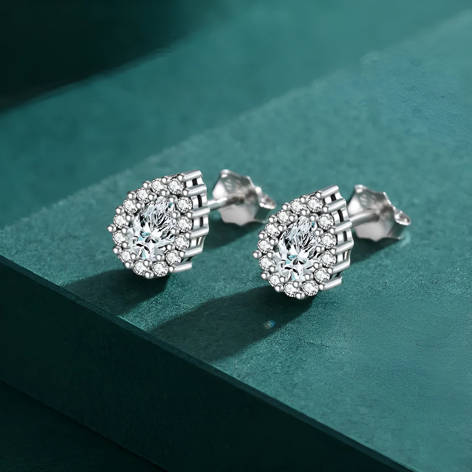 A pair of women's silver drop-shaped ear studs made from 925 sterling silver.