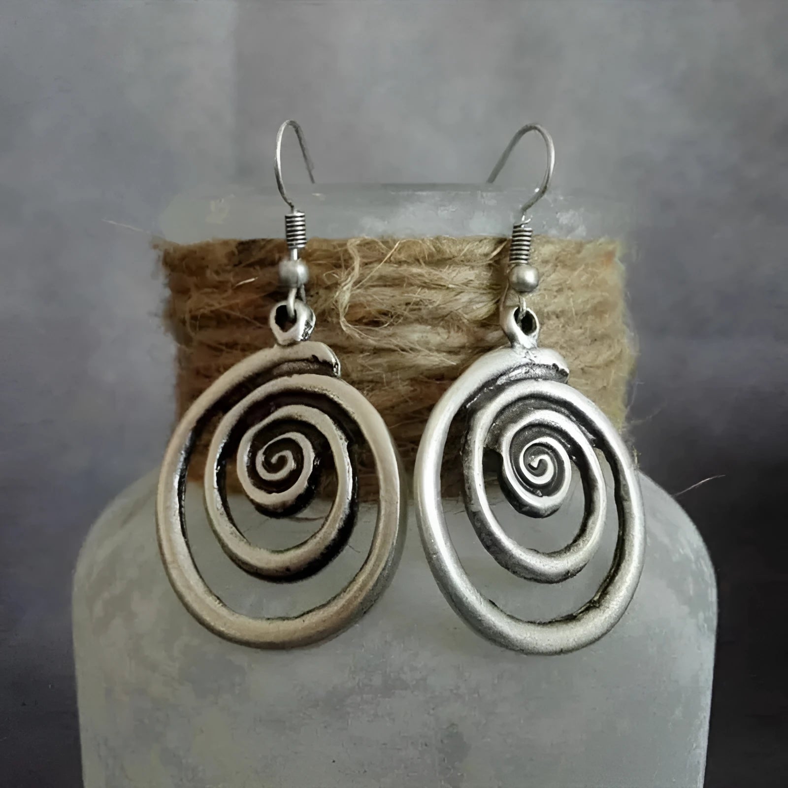 Silver geometric spiral distressed earrings showing alloy construction and 5cm drop length