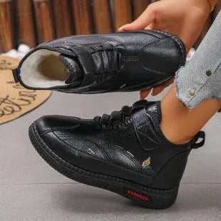 Black women's velvet slipper with non-slip rubber sole and hollow out design
