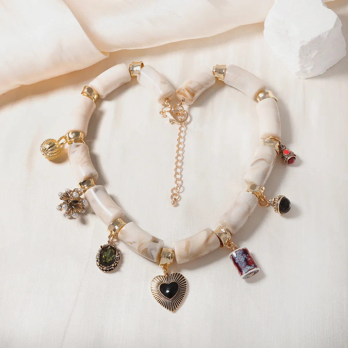 Close-up of a heart-shaped bamboo motif pendant necklace for women on an electroplated chain.