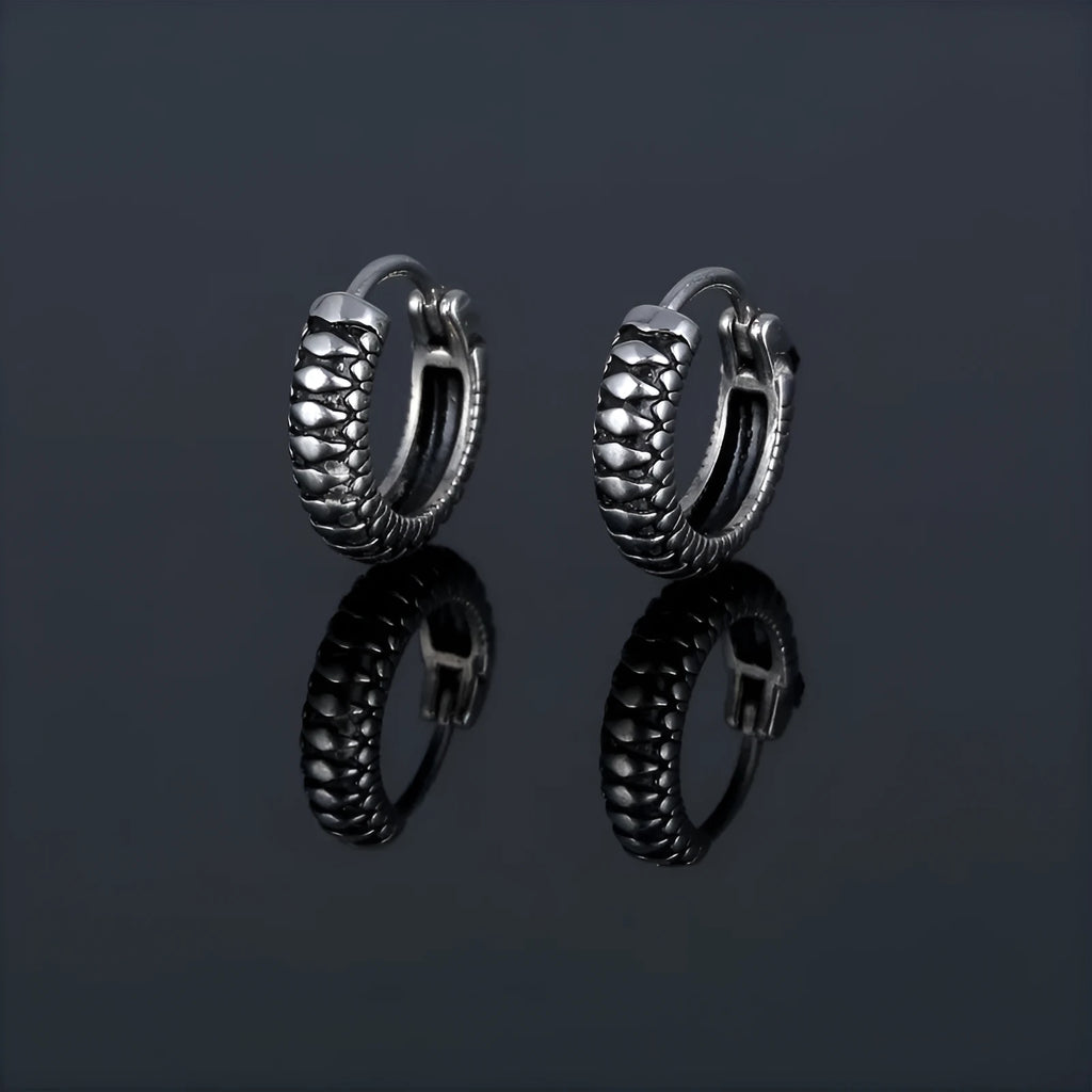 Silver geometric retro twist earrings with stripes made from titanium steel on a white background.