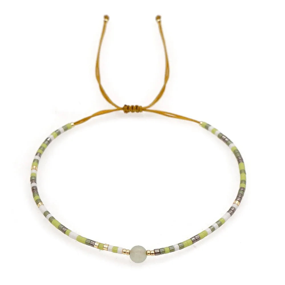 A colourful Bohemian style beaded bracelet with semi-precious stone and glass beads on an adjustable strap.