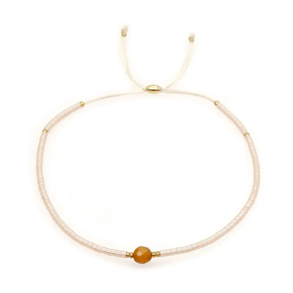 A colourful Bohemian style beaded bracelet with semi-precious stone and glass beads on an adjustable strap.