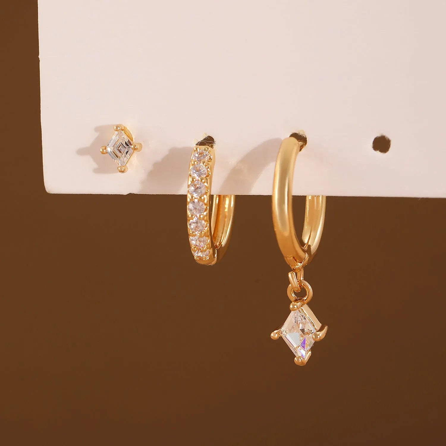 Ladies three-piece geometric earring set with zircon stones in gold and white finish options