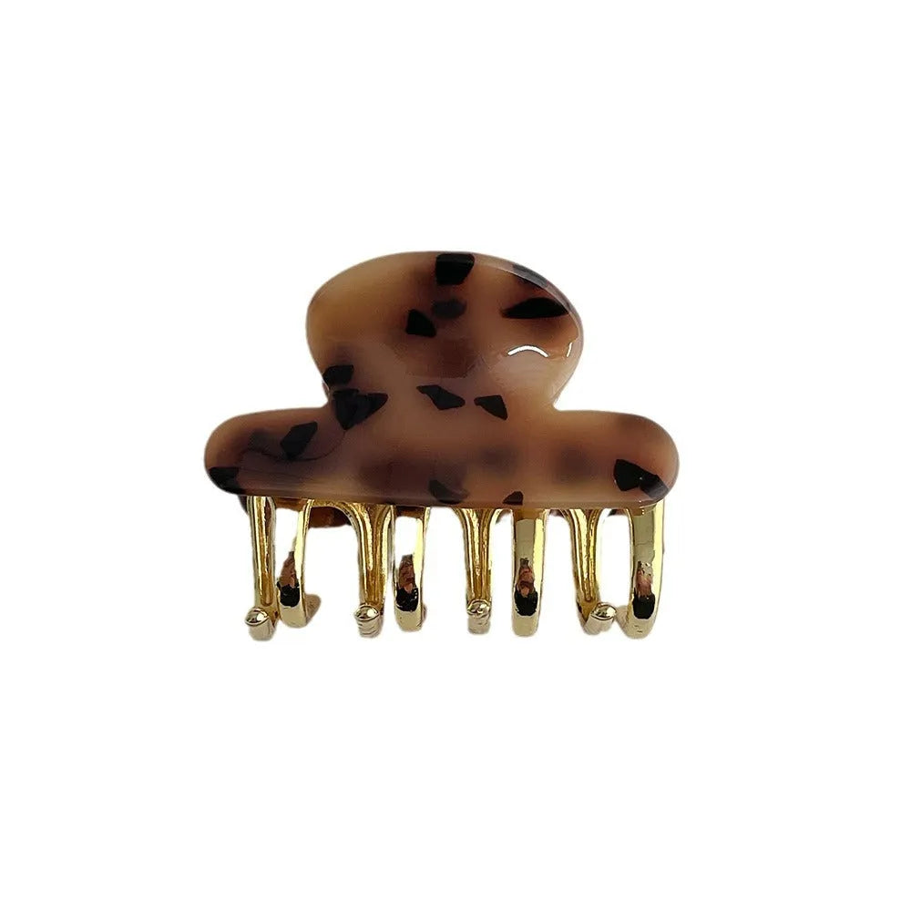 A medium-size retro-style hair barrette with a metal grip, in an alloy acrylic construction.