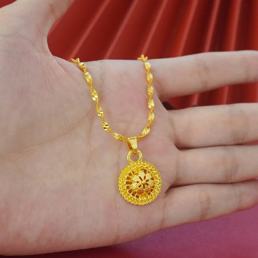 Gold-plated three-piece jewellery set with necklace, earrings, and ring in a floral design.