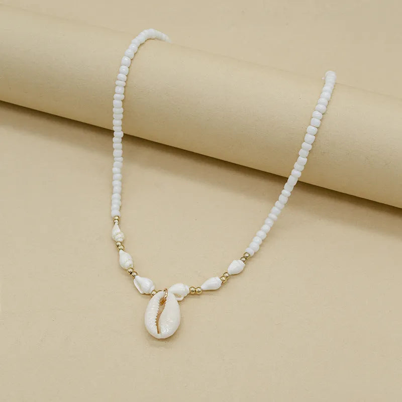 Women's white mother of pearl shell pendant necklace with regular chain on display