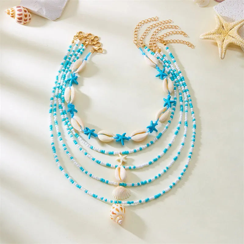 Women's multi-layer necklace set with blue shell pendants and beads, showing five coordinated designs